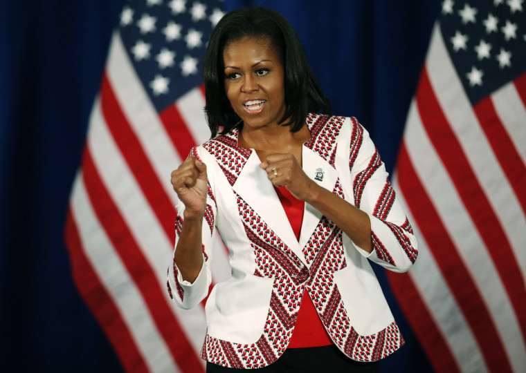 Image: U.S. first lady Michelle Obama gestures as she arrives at a Team USA athletes breakfast in London